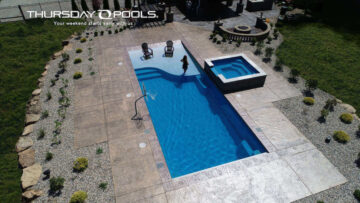 inground pool from Thursday Pools with stamped concrete around