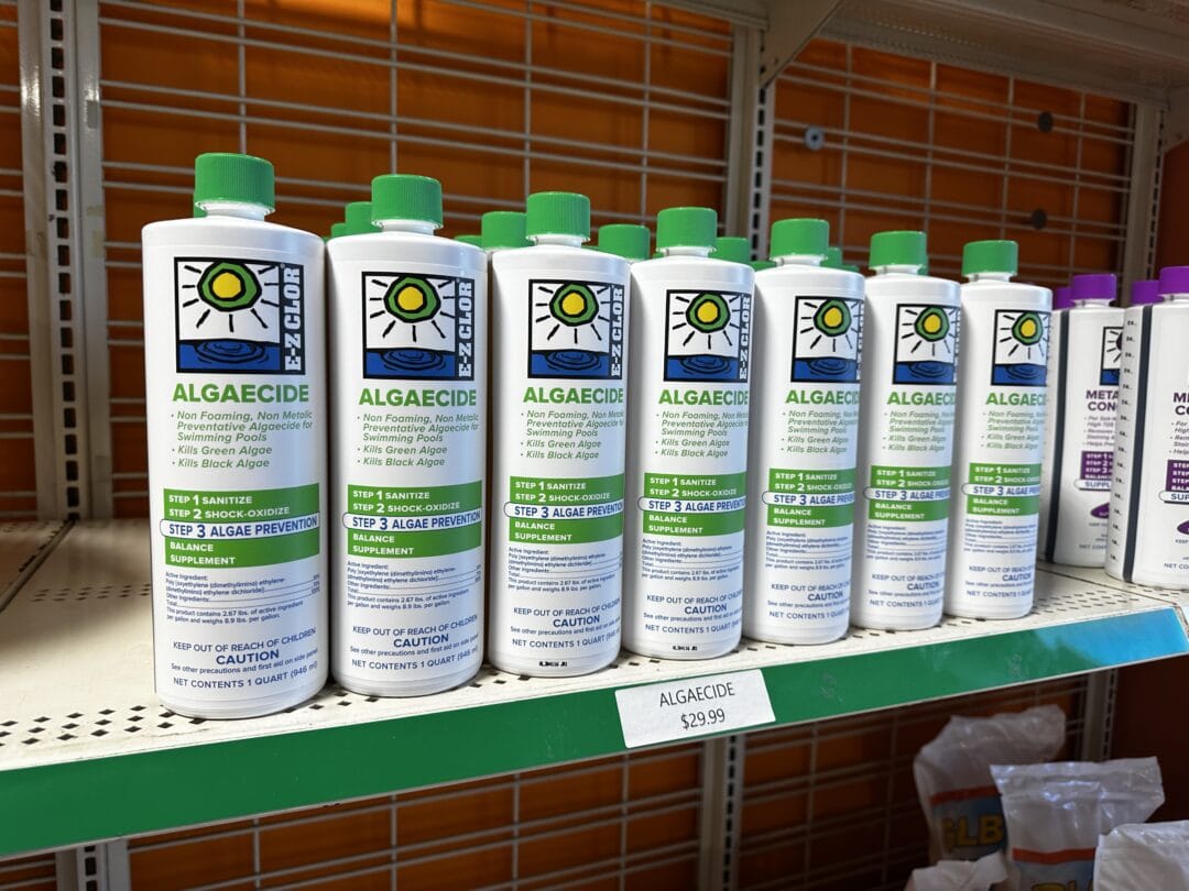 Landscape photo of seven rows of E-Z CLOR algaecide lined up next to one another on a shelf. 