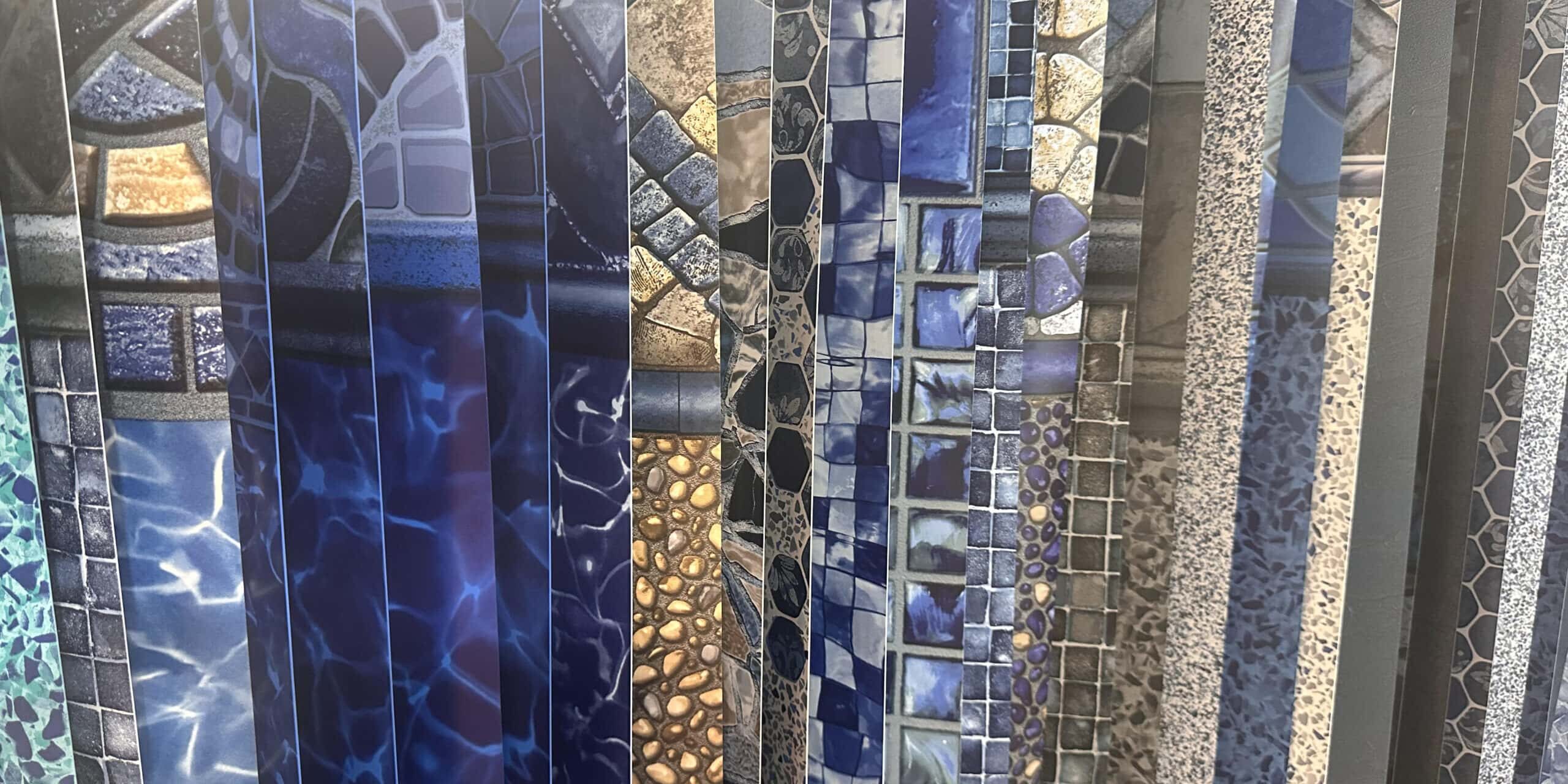 Variety of vinyl liner patterns draped next to one another.