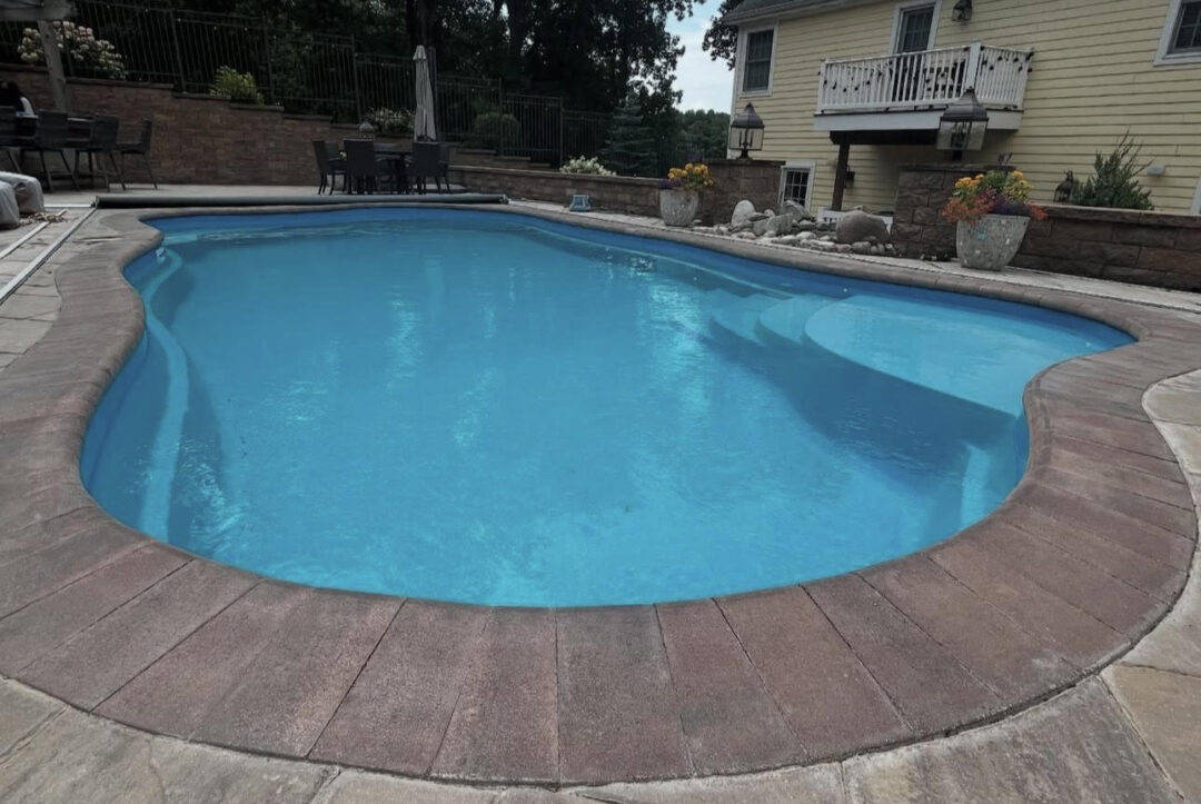 A head-on view of a freeform fiberglass pool.