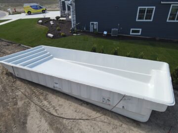 Latham fiberglass pool in a yard getting ready for installation